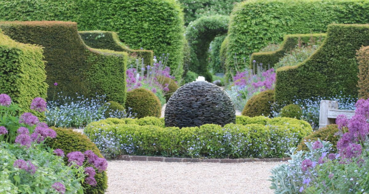 Allium Extravaganza display with purple alliums in the gardens at Arundel Castle