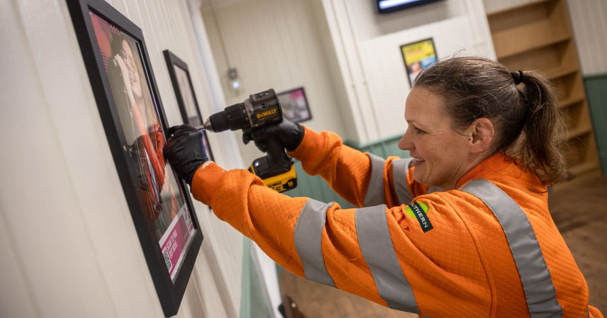 Natalie Parker Southern fixing a poster frame