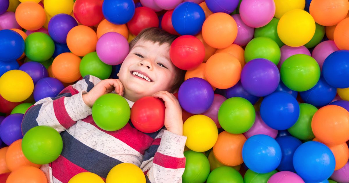 Child in a ball pit at a soft play centre