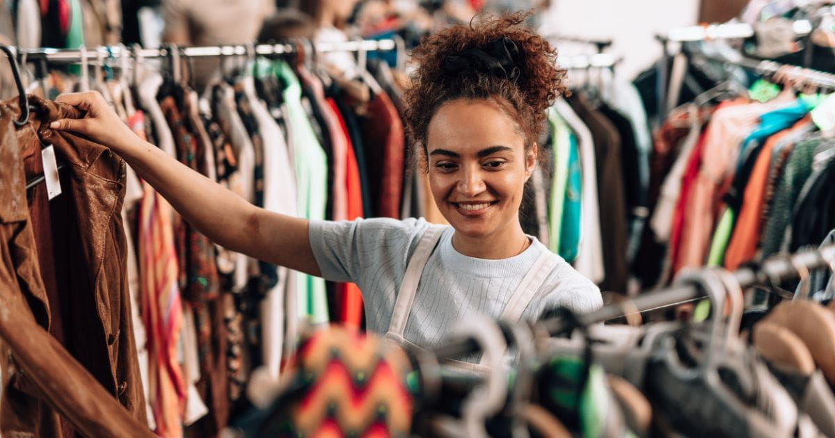 A woman browsing clothing in a shop