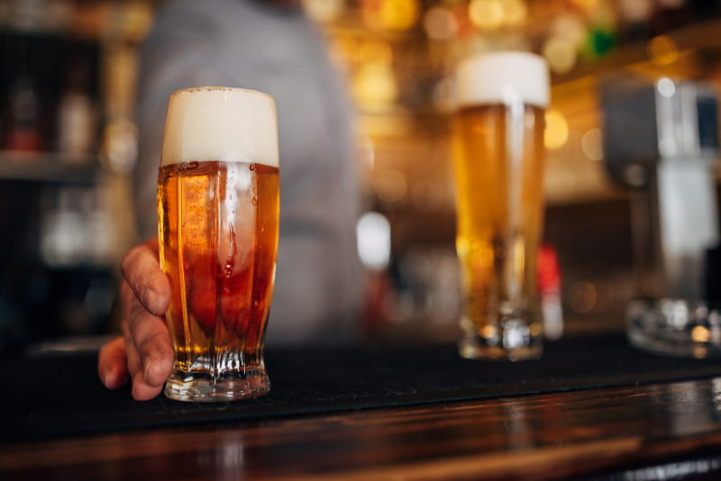 a close up of a bottle and a glass of beer on a table