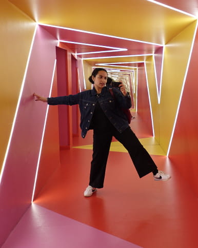 A woman standing in a twisted hallway