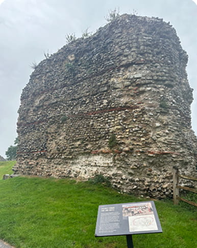 A sign in front of ruins