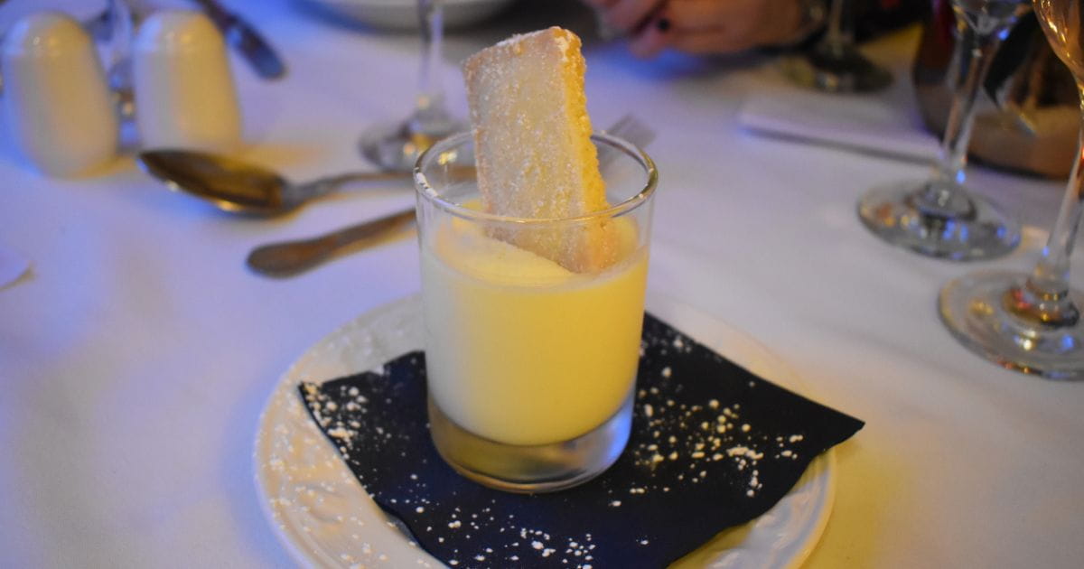 Stock image of a lemon posset on a restaurant table
