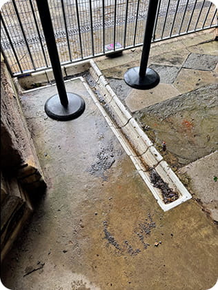 Paved floor with a urinal channel