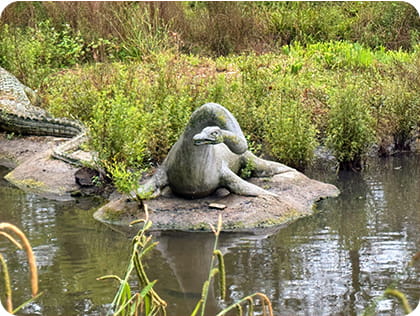 Dinosaur statue in a pond