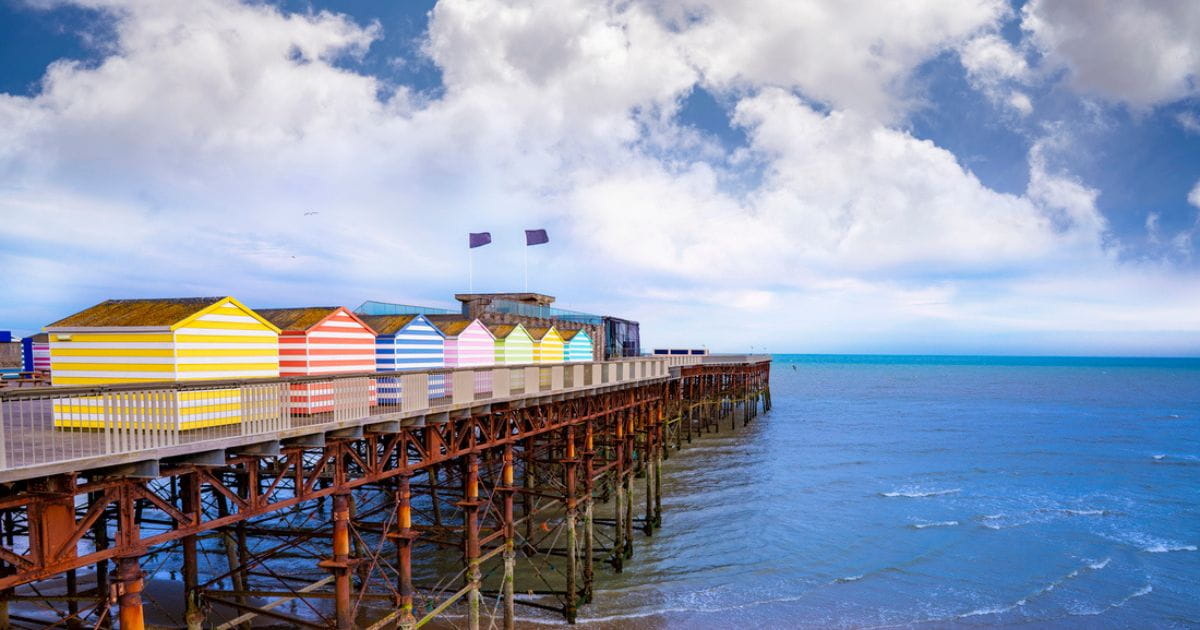 Brightly coloured striped beach cabanas on Hastings pier