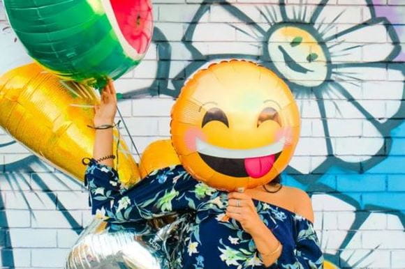 Woman with balloons showing joy