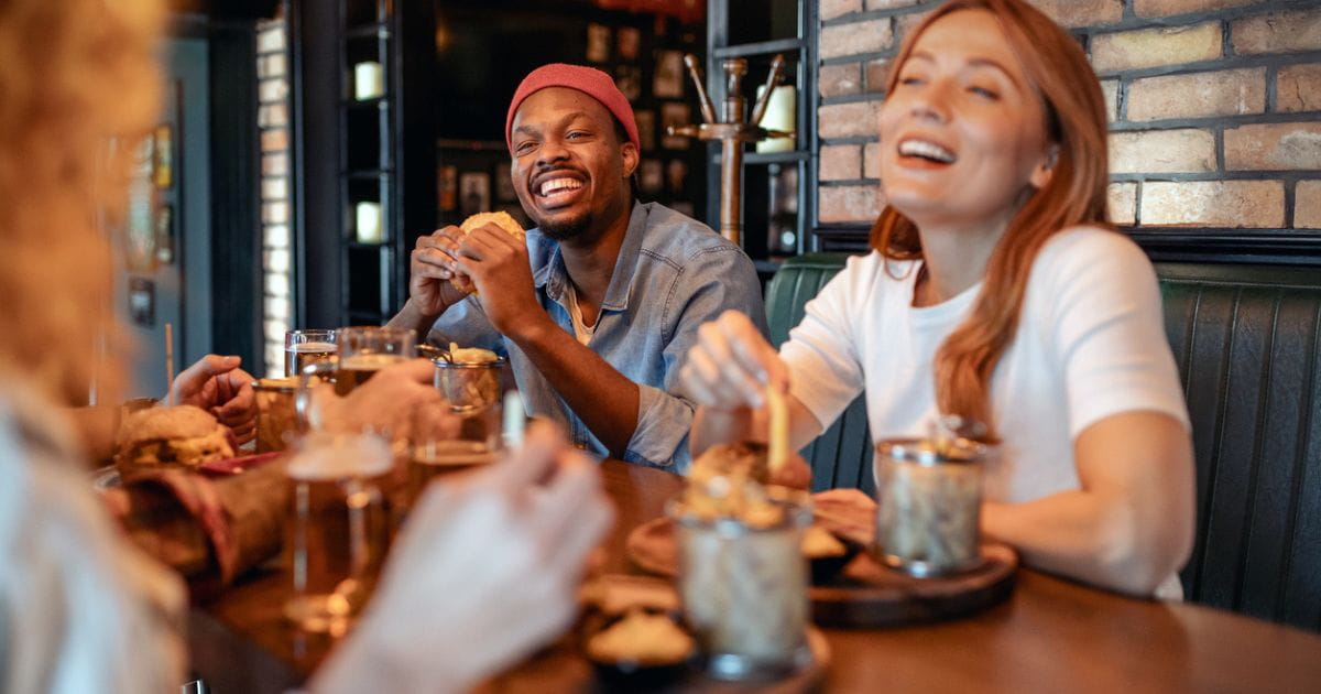stock image of people eating in a pub