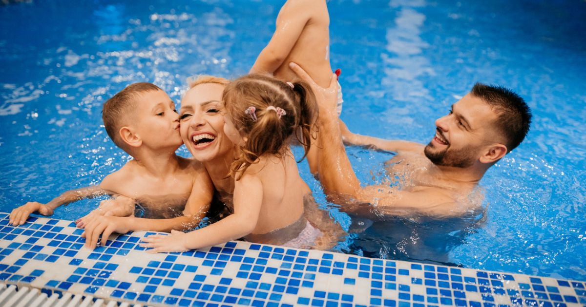 Family having fun in an indoor swimming pool