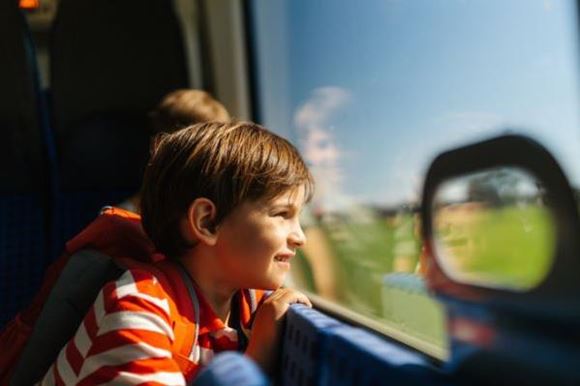 Child look out of a train window