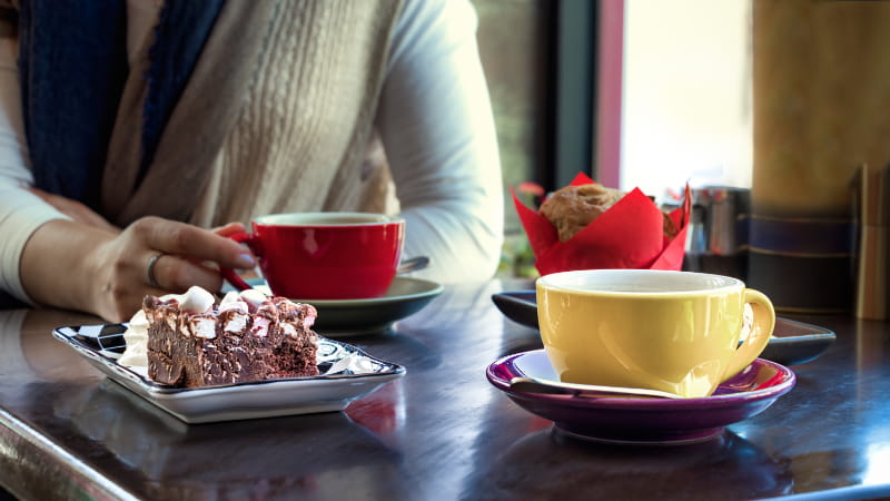 a person sitting at a table with a cake