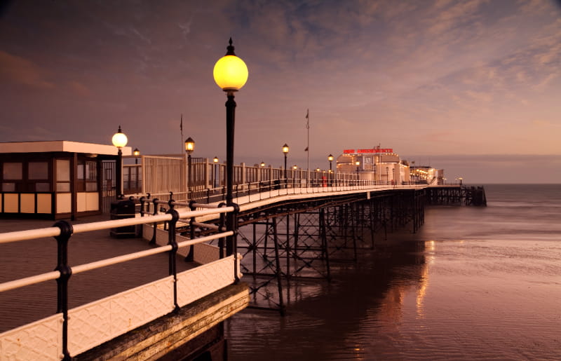 a close up of a pier next to a body of water