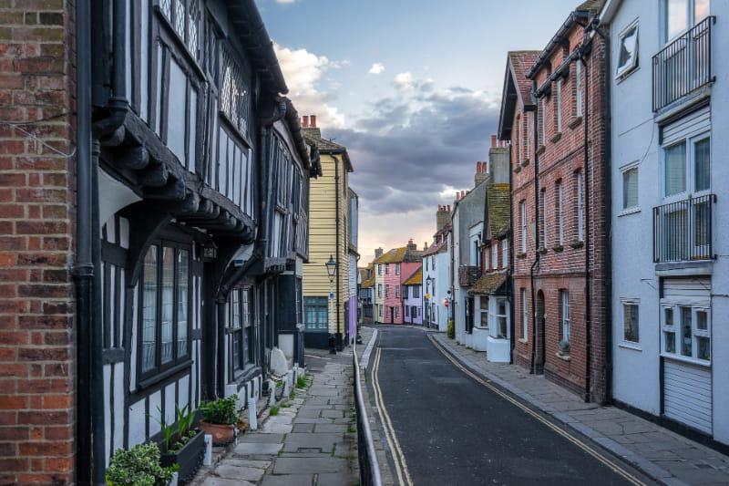 a narrow street in front of a brick building