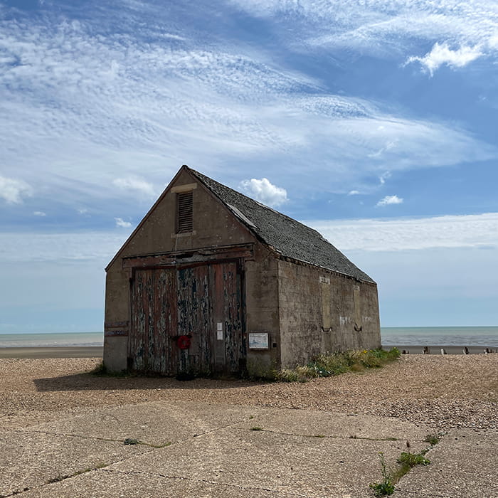 An old building on the coast with the sea in the background