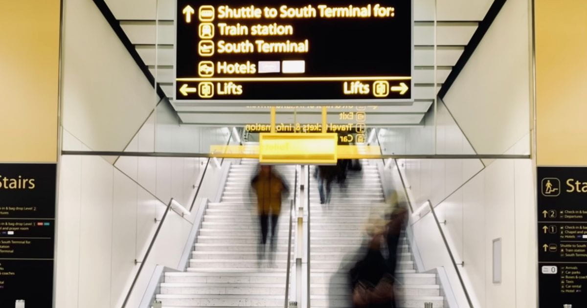 Gatwick Airport terminal with signage to railway station