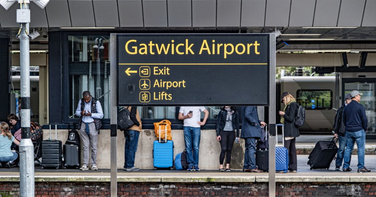 Passengers with luggage at Gatwick airport train station