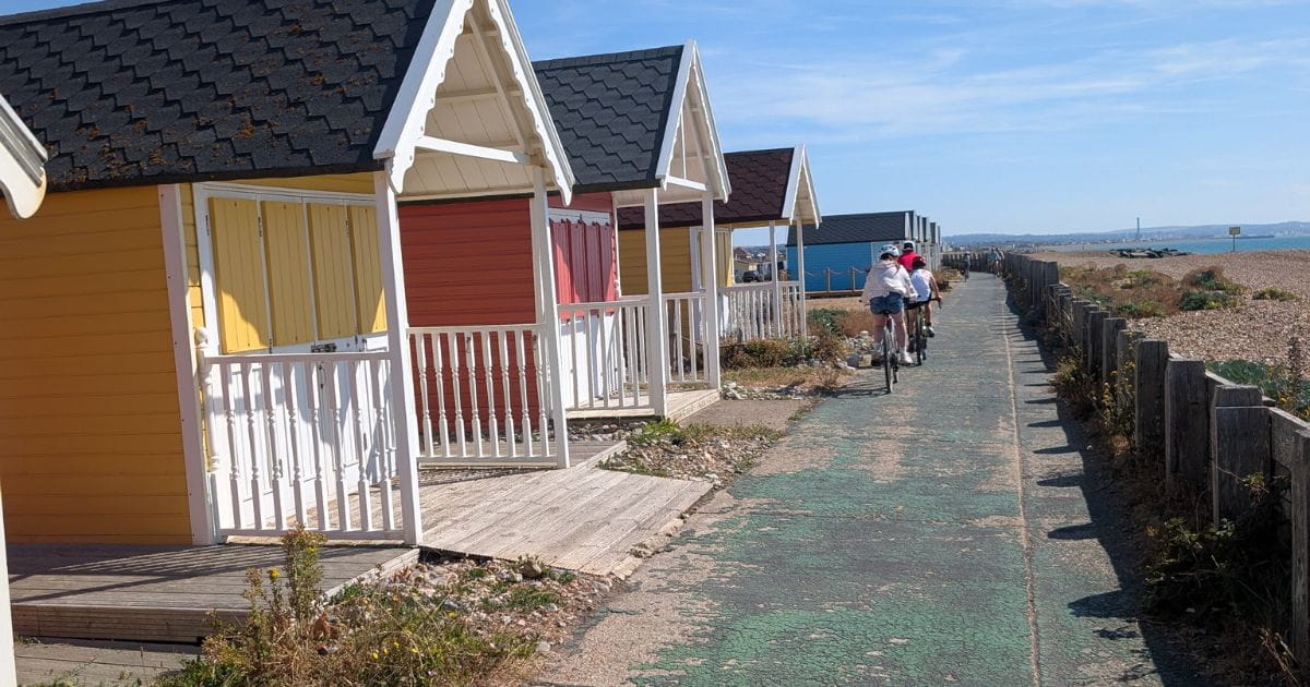 Colourful beach huts and path on Shoreham beach seafront