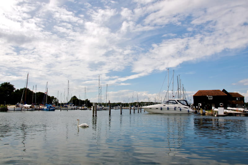 a boat is docked next to a body of water