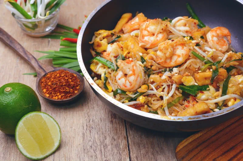 a bowl of food sitting on top of a wooden table