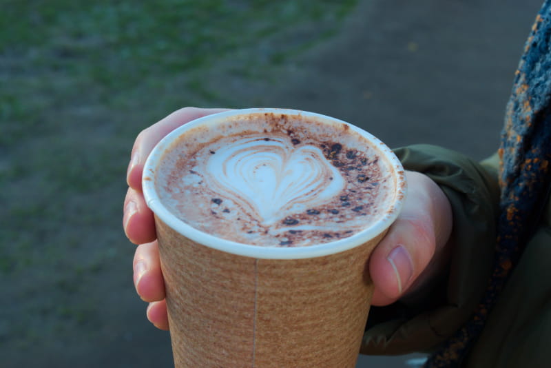 a hand holding a cup of coffee