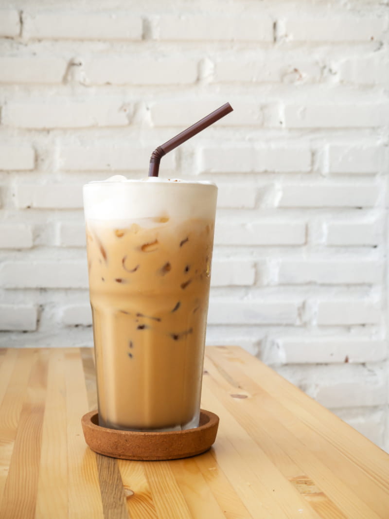 a close up of a coffee cup sitting on top of a wooden table