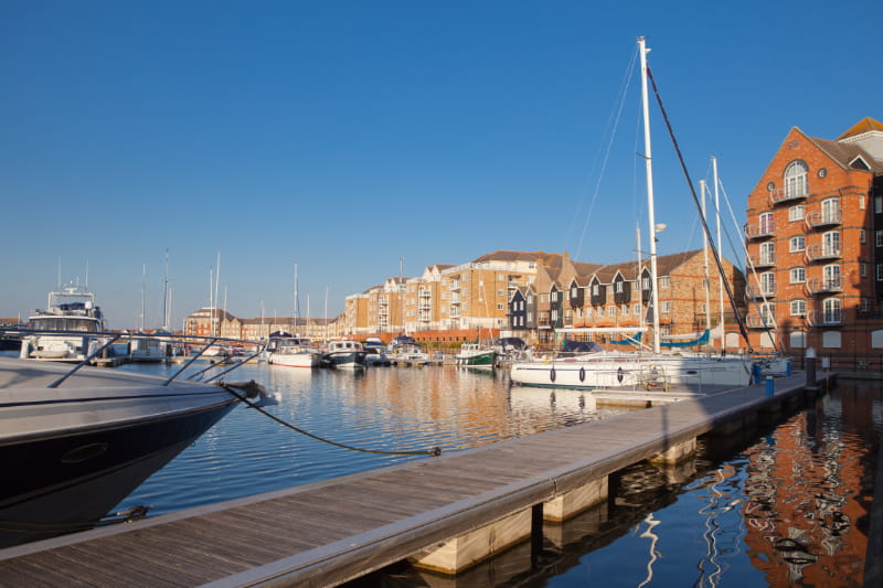 a boat is docked next to a body of water