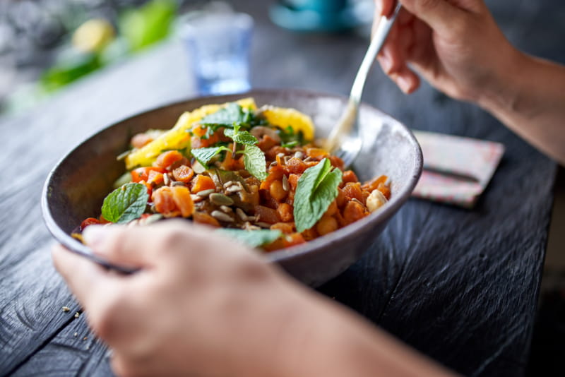 a person holding a plate of food