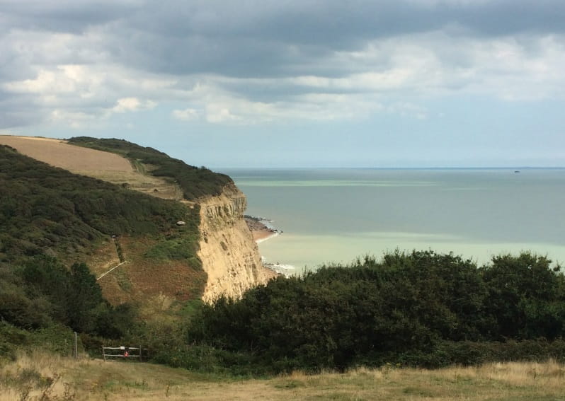 a body of water with a mountain in the background